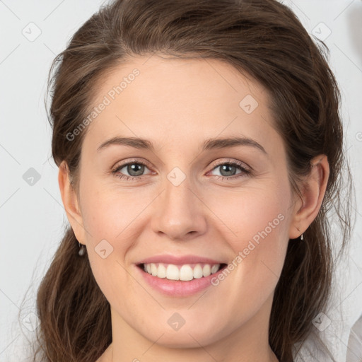 Joyful white young-adult female with medium  brown hair and grey eyes