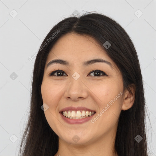 Joyful asian young-adult female with long  brown hair and brown eyes