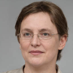 Joyful white adult female with short  brown hair and grey eyes