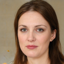 Joyful white young-adult female with long  brown hair and green eyes