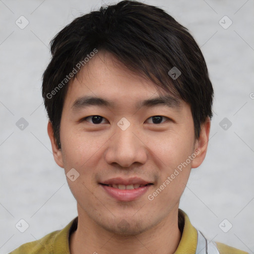 Joyful asian young-adult male with short  brown hair and brown eyes