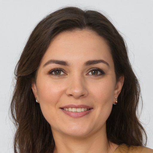 Joyful white young-adult female with long  brown hair and brown eyes