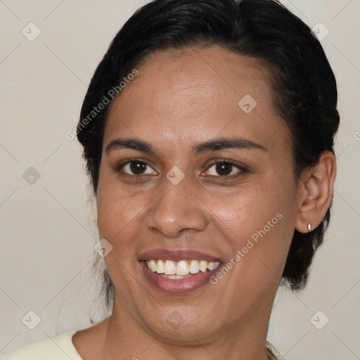 Joyful latino young-adult female with medium  brown hair and brown eyes