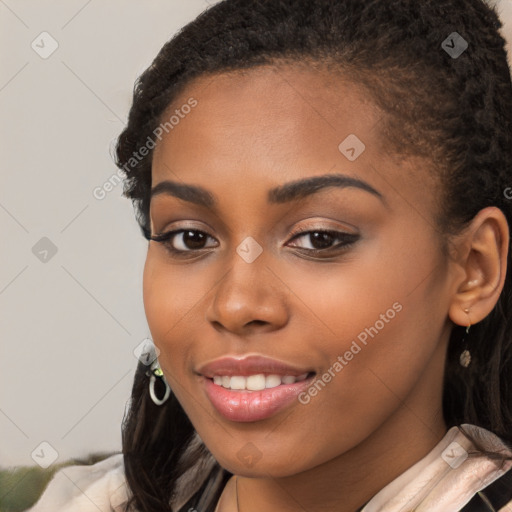 Joyful black young-adult female with long  brown hair and brown eyes