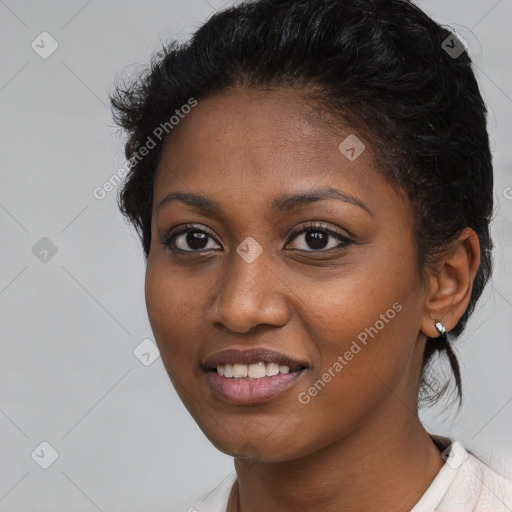 Joyful black young-adult female with short  brown hair and brown eyes