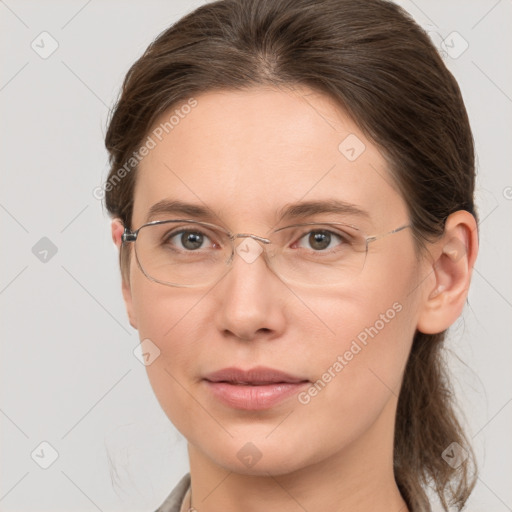 Joyful white adult female with medium  brown hair and grey eyes