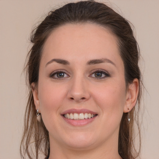 Joyful white young-adult female with long  brown hair and grey eyes