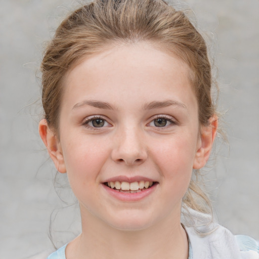 Joyful white child female with medium  brown hair and grey eyes