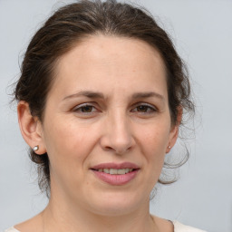 Joyful white adult female with medium  brown hair and brown eyes