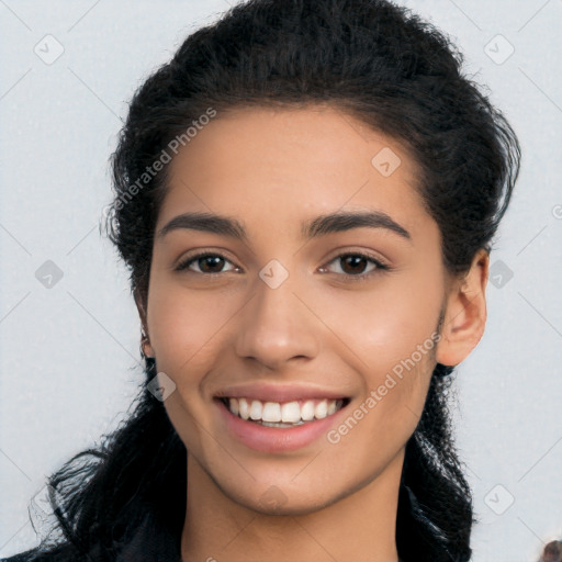 Joyful latino young-adult female with long  black hair and brown eyes