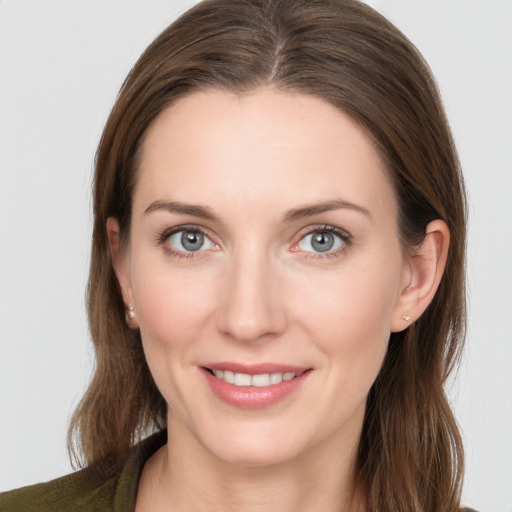 Joyful white young-adult female with medium  brown hair and grey eyes