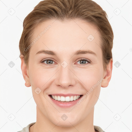 Joyful white young-adult female with short  brown hair and grey eyes