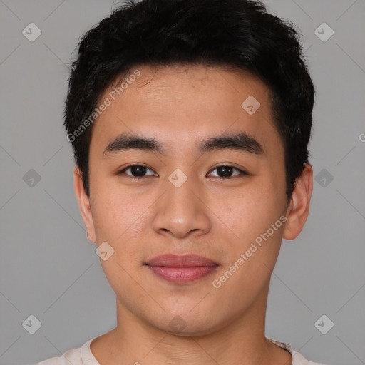 Joyful asian young-adult male with short  black hair and brown eyes