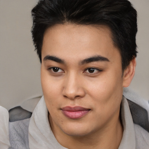 Joyful asian young-adult male with short  brown hair and brown eyes