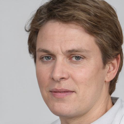 Joyful white adult male with short  brown hair and grey eyes