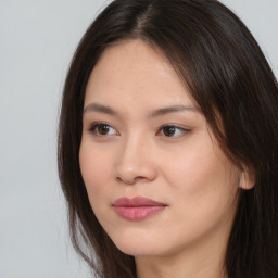 Joyful asian young-adult female with long  brown hair and brown eyes