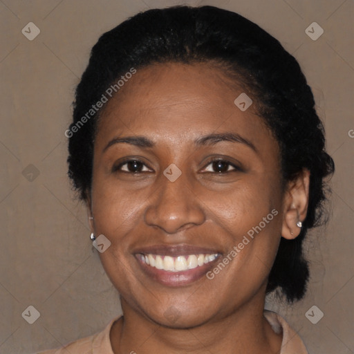 Joyful black adult female with medium  brown hair and brown eyes