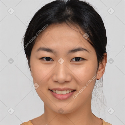 Joyful asian young-adult female with medium  black hair and brown eyes