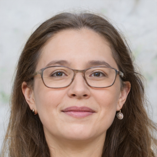 Joyful white adult female with long  brown hair and grey eyes