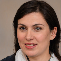 Joyful white adult female with medium  brown hair and brown eyes