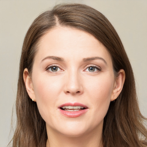 Joyful white young-adult female with long  brown hair and grey eyes