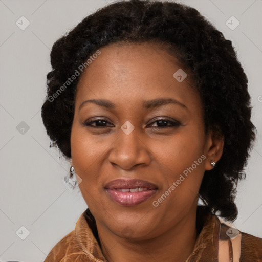 Joyful black adult female with long  brown hair and brown eyes