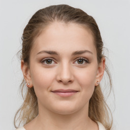 Joyful white young-adult female with medium  brown hair and grey eyes