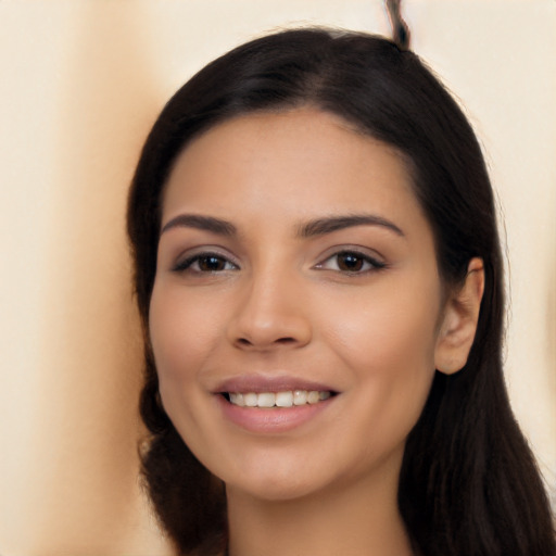 Joyful latino young-adult female with long  black hair and brown eyes