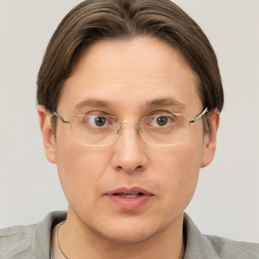 Joyful white adult male with short  brown hair and grey eyes