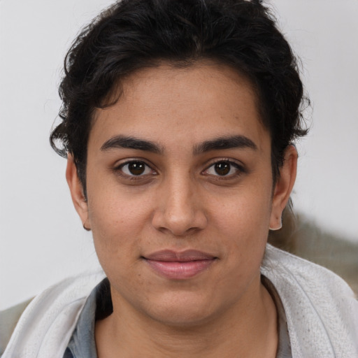 Joyful latino young-adult female with short  brown hair and brown eyes