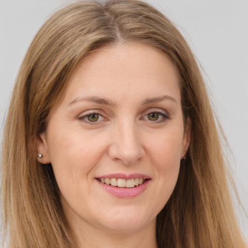 Joyful white adult female with long  brown hair and brown eyes