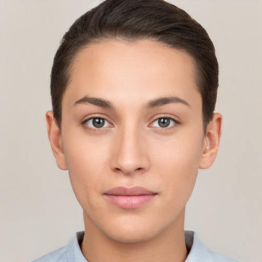 Joyful white young-adult female with short  brown hair and brown eyes