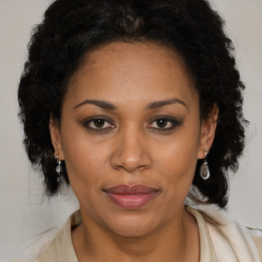Joyful latino adult female with medium  brown hair and brown eyes