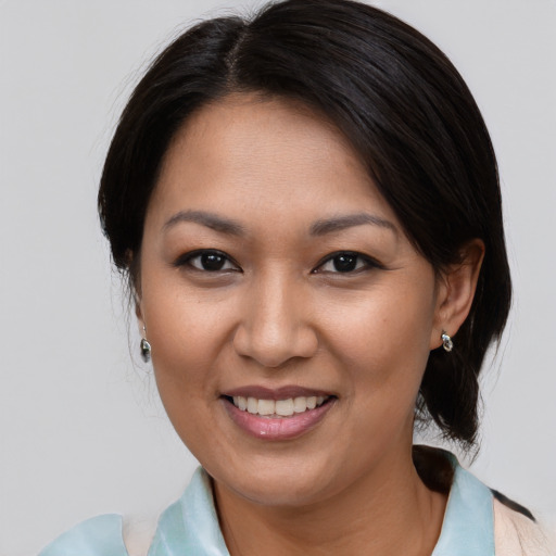 Joyful asian young-adult female with medium  brown hair and brown eyes