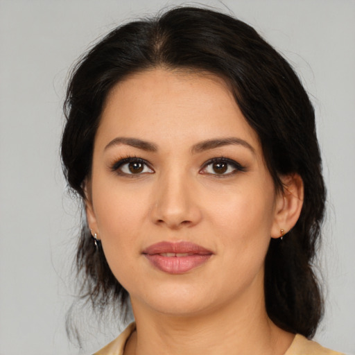 Joyful latino young-adult female with medium  brown hair and brown eyes