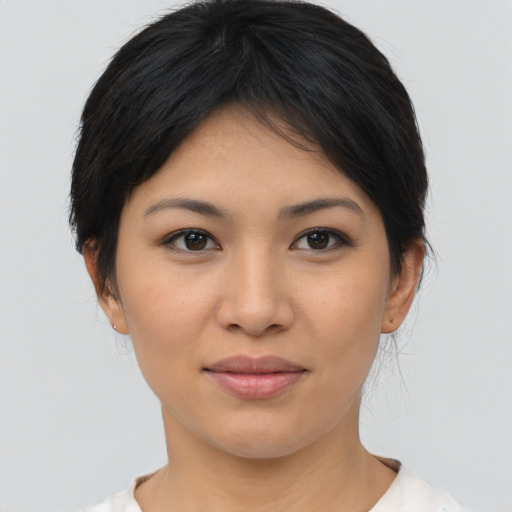 Joyful asian young-adult female with medium  brown hair and brown eyes