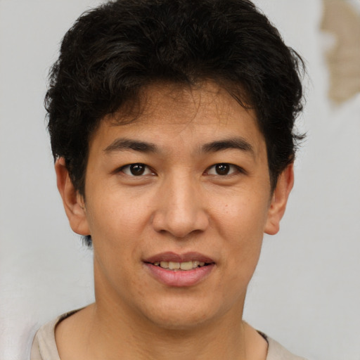 Joyful asian young-adult male with short  brown hair and brown eyes