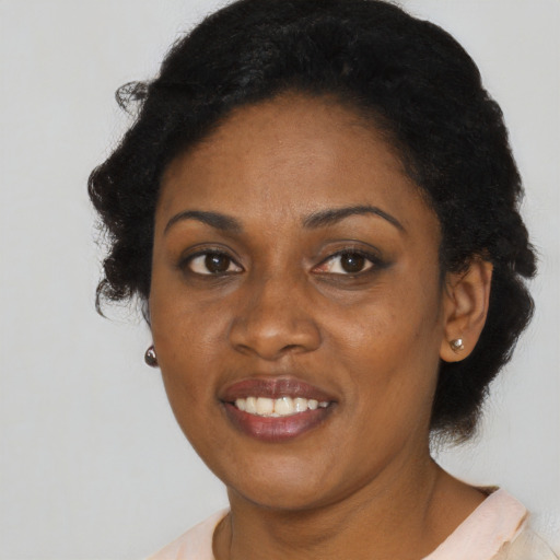 Joyful black adult female with short  brown hair and brown eyes