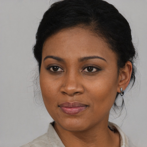 Joyful black young-adult female with medium  black hair and brown eyes