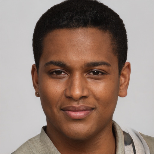 Joyful black young-adult male with short  brown hair and brown eyes