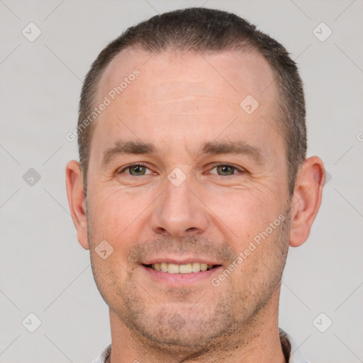 Joyful white adult male with short  brown hair and brown eyes