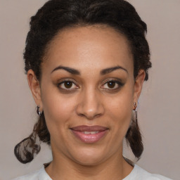 Joyful black adult female with medium  brown hair and brown eyes