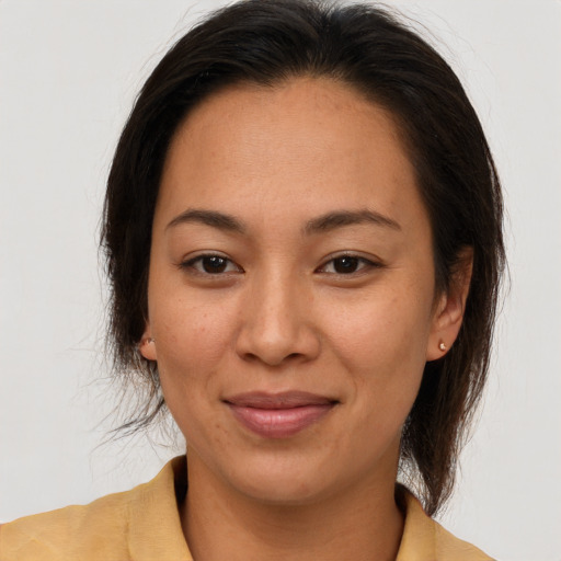 Joyful latino adult female with medium  brown hair and brown eyes