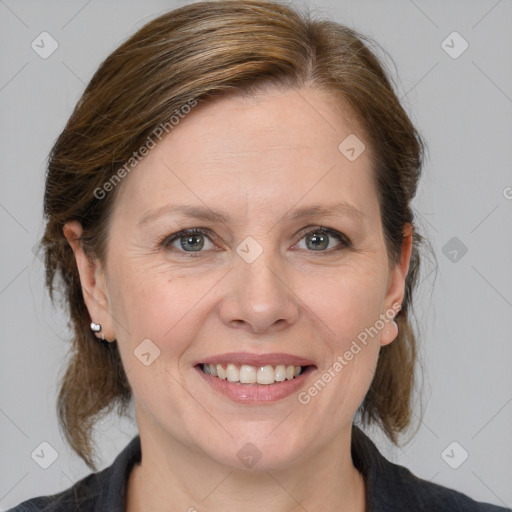 Joyful white adult female with medium  brown hair and grey eyes