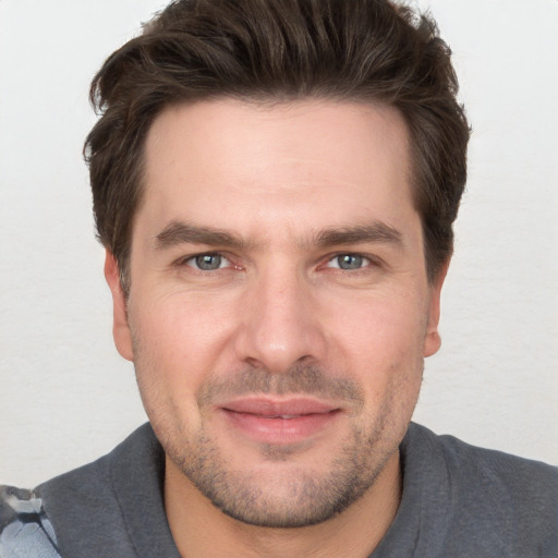 Joyful white adult male with short  brown hair and brown eyes