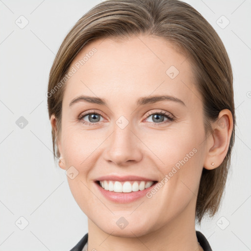 Joyful white young-adult female with medium  brown hair and grey eyes