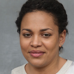 Joyful latino young-adult female with short  brown hair and brown eyes