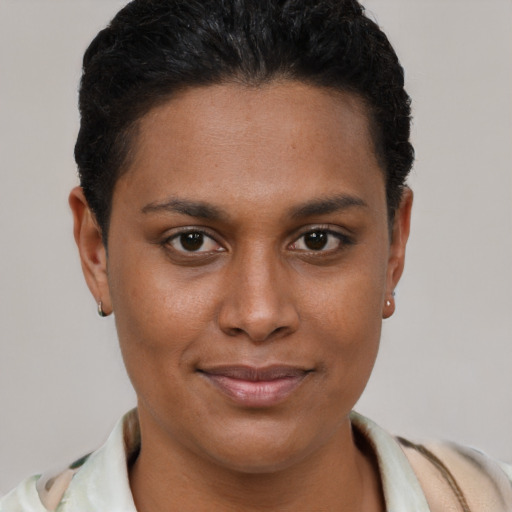 Joyful black young-adult female with short  brown hair and brown eyes