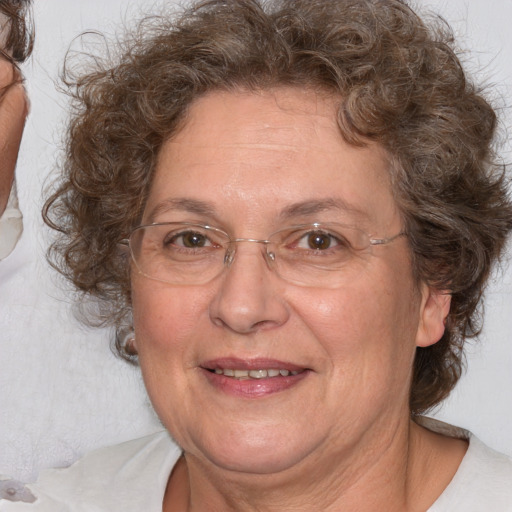 Joyful white middle-aged female with medium  brown hair and brown eyes