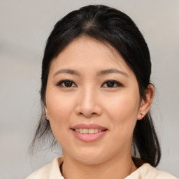 Joyful asian young-adult female with medium  black hair and brown eyes